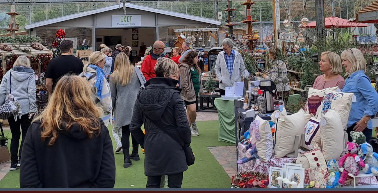 Visitors browsing stalls and handmade gifts at a previous market at Shallowmead