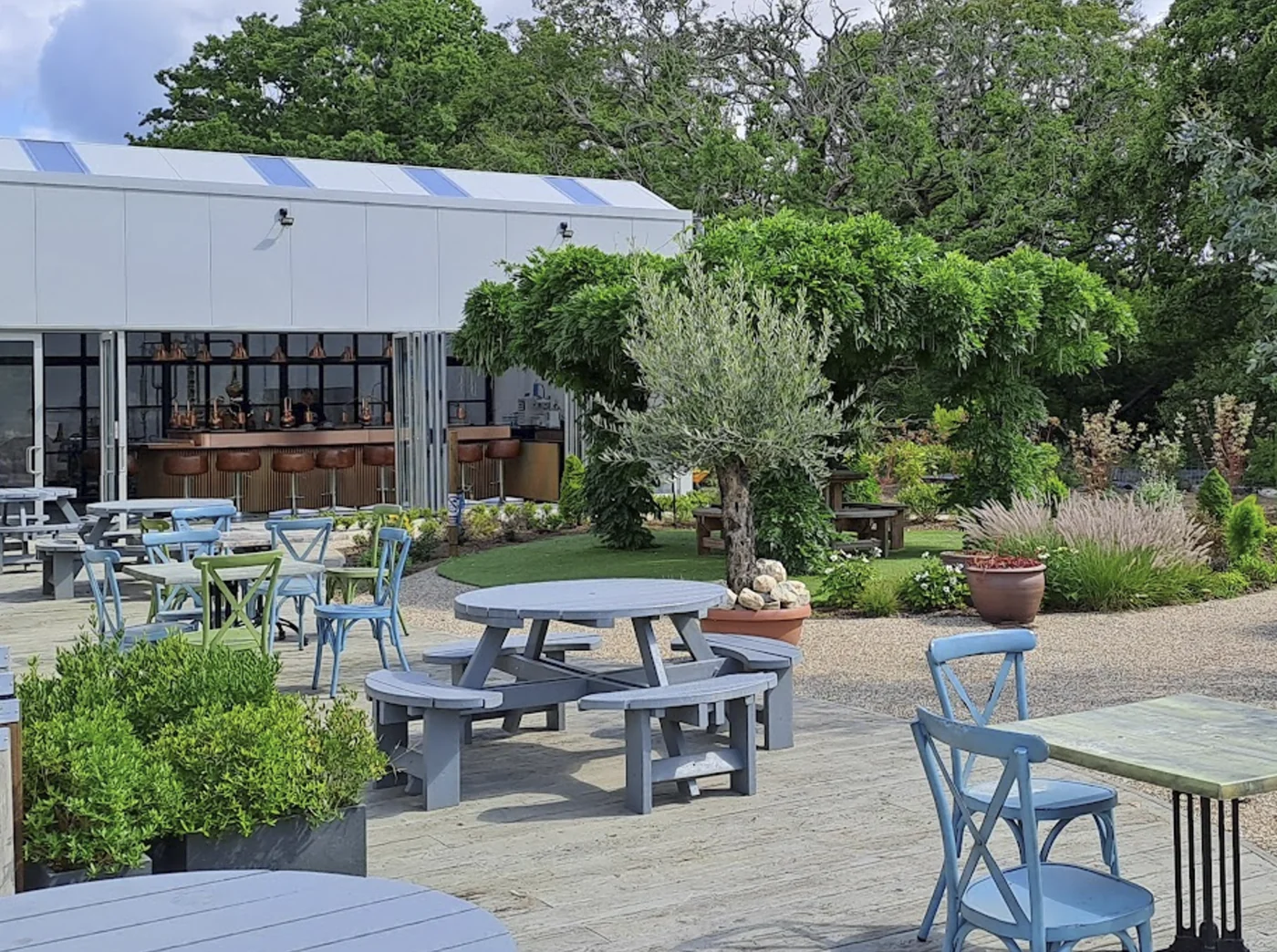 Garden seating at Shallowmead with the 820 Spirits distillery in the background